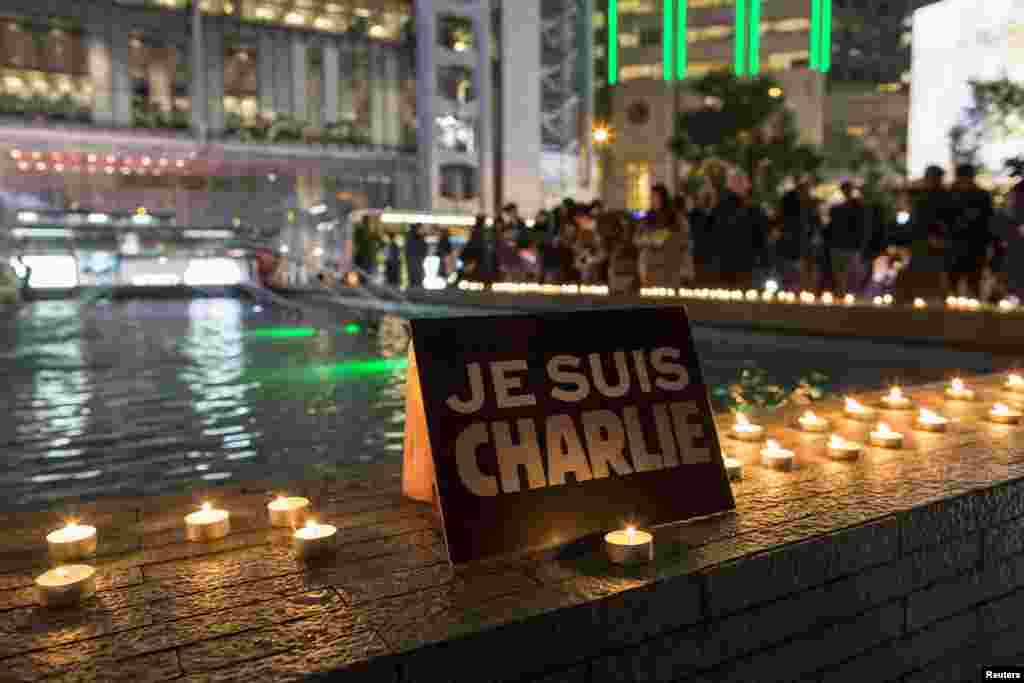 A placard reading &quot;I am Charlie&quot; and candles are placed as a tribute during a candlelight vigil at the financial Central district in Hong Kong, Jan. 9, 2015.
