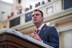 FILE - In this Feb. 3, 2020, file photo, Oklahoma Gov. Kevin Stitt delivers his State of the State address in Oklahoma City.