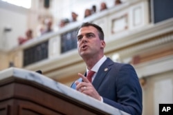 FILE - In this Feb. 3, 2020, file photo, Oklahoma Gov. Kevin Stitt delivers his State of the State address in Oklahoma City.