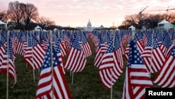 Thousands of U.S. flags are seen at the National Mall, to represent the people who are unable to travel to Washington for the inauguration, Jan. 18, 2021.