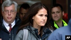 Former University of Southern California soccer coach Laura Janke departs federal court, May 14, 2019, in Boston, where she pleaded guilty to charges in a nationwide college admissions bribery scandal.