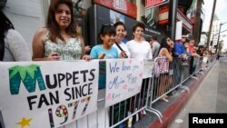 FILE - Fans wait at the premiere of "Muppets Most Wanted" at El Capitan theatre in Hollywood, Calif., March 11, 2014. 