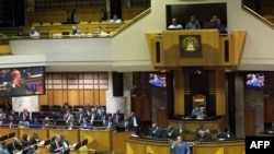 South African President Jacob Zuma appears on screens as he answers questions during the last presidential answer session this year, in the South African Parliament, in Cape Town, Nov. 2, 2017.