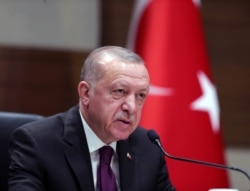 FILE - Turkish President Recep Tayyip Erdogan speaks during a news conference ahead of a visit to Algeria, at Ataturk airport in Istanbul, Turkey, January 26, 2020.
