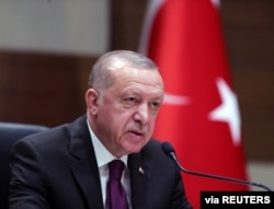 FILE - Turkish President Recep Tayyip Erdogan speaks during a news conference ahead of a visit to Algeria, at Ataturk airport in Istanbul, Turkey, January 26, 2020.