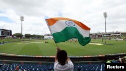 A fan waves an India flag in the stands before a cricket game on Dec.26, 2023. The Indian government has expressed concerns about Indian students being deported from the United States.