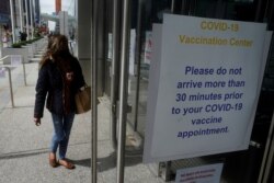 People arrive at the Javits Center mass vaccination location amid the coronavirus pandemic in the Manhattan borough of New York City, New York, April 13, 2021.