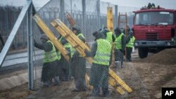 Prison inmates build a second protective fence on the border between Hungary and Serbia, near Kelebia, 178 kilometers southeast of Budapest, Hungary, March 1, 2017.