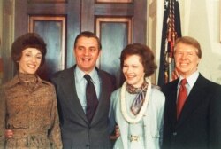 FILE - President Jimmy Carter, right, and Rosalynn Carter, second from right, pose with Vice President Walter Mondale and wife, Joan Mondale, left, following Carter's inauguration in the White House, Jan. 21, 1977.