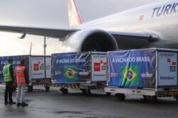 FILE - Refrigerated containers with supplies to produce China's Sinovac vaccines against the coronavirus disease arrive at Sao Paulo International Airport in Guarulhos, Brazil, April 19, 2021.