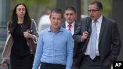 FILE - Former Goldman Sachs executive Roger Ng, center, leaves Brooklyn federal court with his legal team May 6, 2019, in New York. On Friday, April 8, 2022, he was convicted of bribery and other corruption charges. 