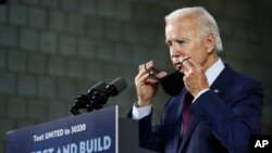 FILE - Democratic presidential candidate former Vice President Joe Biden puts on a face mask after speaking at an event in Lancaster, Pennsylvania, June 25, 2020.
