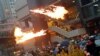 An anti-extradition bill protester throws a Molotov cocktail as protesters clash with riot police during a rally to demand democracy and political reforms, at Tsuen Wan, in Hong Kong.