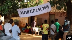 FILE - People line up to cast their ballots in Guinea-Bissau's legislative elections in Bissau, June 4, 2023. 