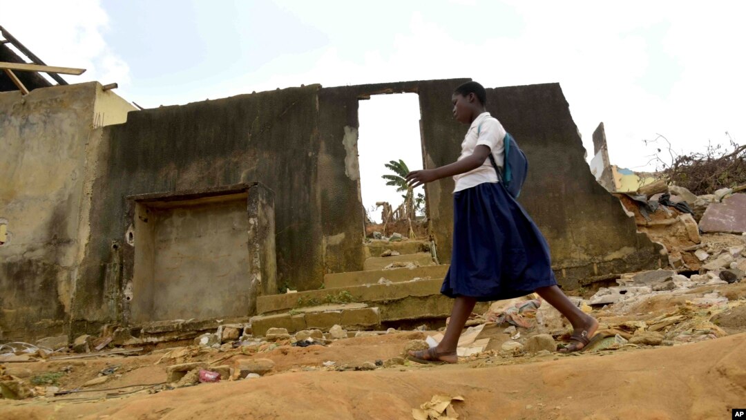 A school girl walks past houses that were demolished on public health grounds in the Gesco neighborhood of Abidjan, Ivory Coast, Feb. 28, 2024.