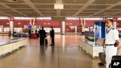 FILE - Tourists pick up their bags at the arrival hall of the airport in Sharm el-Sheikh, Egypt, Nov. 7, 2015. Tourism numbers have fallen in Egypt in the tumultuous five years that followed the 2011 revolution, and after the suspected bombing of a Russian passenger jet flying over Sinai in November.