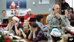 Kepala Staf NORAD dan USNORTHCOM, Mayjen Charles D. Luckey bergabung dengan para relawan yang melayani panggilan telepon dari anak-anak di seluruh dunia yang menanyakan Sinterklas, 24 Desember 2014. (Foto: Dok)