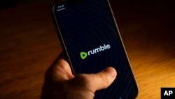 FILE - An iPhone displays the logo for the Rumble app, Saturday, Sept. 23, 2023, in Washington. Rumble is an alternative video sharing platform that has been criticized for allowing extremism, bigotry, election disinformation and conspiracy theories.