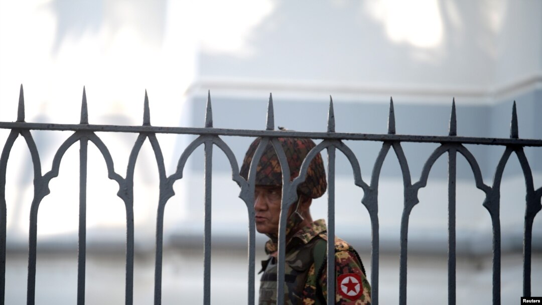 A Myanmar soldier looks on as he stands inside city hall after soldiers occupied the building, in Yangon, Myanmar, Feb. 2, 2021. 