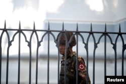 A Myanmar soldier looks on as he stands inside city hall after soldiers occupied the building, in Yangon, Myanmar, Feb. 2, 2021.