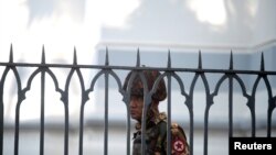 A Myanmar soldier looks on as he stands inside city hall after soldiers occupied the building, in Yangon, Myanmar, Feb. 2, 2021. 