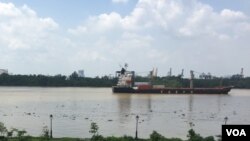 A container ship moves along the Saigon River, used to ship the kinds of exports that have increased Vietnam’s role in global trade.