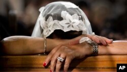 FILE - A Coptic Christian grieves during prayers for the departed, remembering the victims of Thursday's crash of EgyptAir flight 804, at Al-Boutrossiya Church, the main Coptic Cathedral complex, in Cairo, Egypt,May 22, 2016.