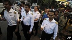 India's national carrier Air India pilots, who are on strike for the ninth consecutive day, join a rally against corruption in Kolkata, May 5, 2011