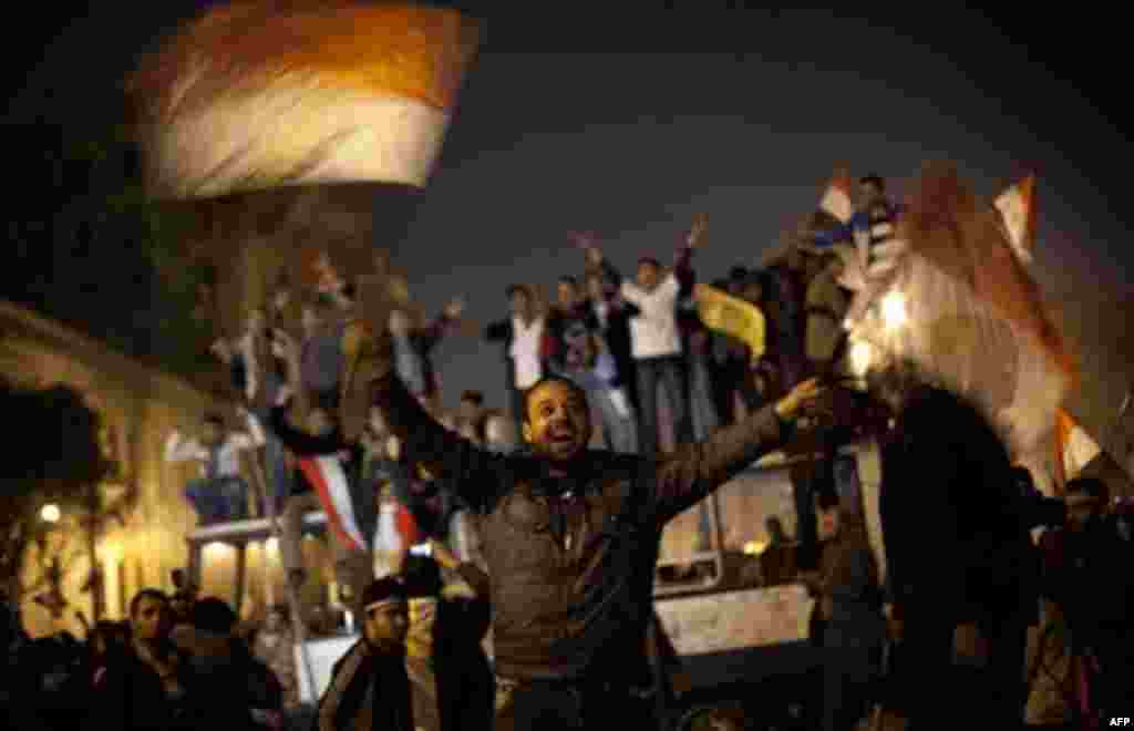 Anti-government protesters celebrate in Tahrir Square in downtown Cairo, Egypt , Egypt Friday, Feb. 11, 2011. Fireworks burst over Tahrir Square and Egypt exploded with joy and tears of relief after pro-democracy protesters brought down President Hosni Mu