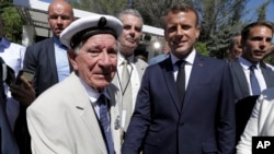 French President Emmanuel Macron shakes hands to a veteran during a ceremony marking the 75th anniversary of the WWII Allied landings in Provence, in Saint-Raphael, southern France, Aug. 15, 2019. 