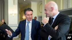FILE - World Athletics president Sebastian Coe, left, speaks with FIFA president Gianni Infantino at the opening of an Olympic Summit, in Lausanne, Switzerland, Oct. 8, 2016.