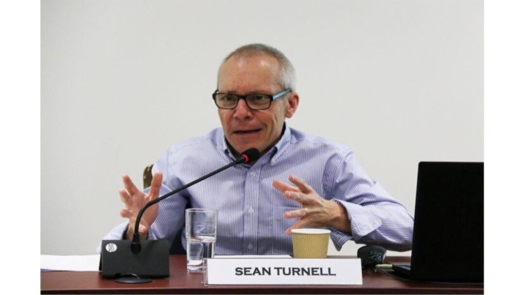 FILE - Sean Turnell discusses economic reforms by Myanmar's NLD government at a seminar in Singapore, May 2018. (ISEAS-Yusof Ishak Institute/via Reuters)