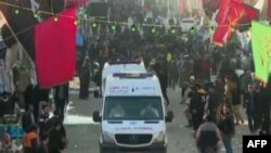 FILE - An image grab from a video released by state-run Iran Press news agency on January 3, 2024 shows an ambulance near the site where two explosions in quick succession struck a crowd marking the anniversary of the 2020 killing of Guards general Qasem Soleima.