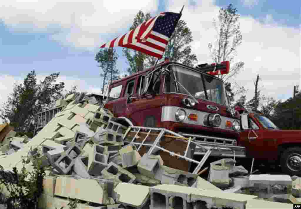 Debris covers fire trucks at the Eoline Volunteer Fire Department near Centreville, Ala., Thursday, April 28, 2011, where a tornado struck the day before. Massive tornadoes tore a town-flattening streak across the South, killing at least 269 people in six