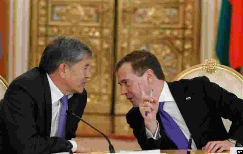 Russian President Dmitry Medvedev, right, speaks to Kyrgyz President Almazbek Atambayev during a summit of the Collective Security Treaty Organization in the Kremlin in Moscow, Tuesday, Dec. 20, 2011. (AP Photo/RIA Novosti, Dmitry Astakhov, Presidential P