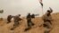 Fighters from Badr Brigades Shiite militia clash with Islamic State group militants at the front line on the outskirts of Fallujah, Anbar province, Iraq, June 1, 2015. 
