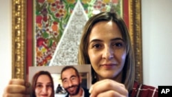 Aya Al-Umari, whose brother Hussein was killed in the Christchurch mosque attacks, poses holding a photo of herself and her brother, in Christchurch, New Zealand, July 30, 2019. 