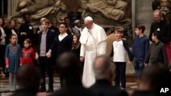 Pope Francis holds hands with children as he celebrates a prayer for peace in South Sudan and the Democratic Republic of the Congo, inside St. Peter's Basilica, at the Vatican, Nov. 23, 2017.