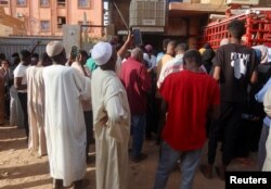 FILE—Residents and displaced people try to access the internet via Starlink in the city of Omdurman, Sudan, March 9, 2024.