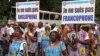 FILE - Demonstrators carry banners as they take part in a march voicing their opposition to independence or more autonomy for the Anglophone regions, in Douala, Cameroon Oct. 1, 2017.