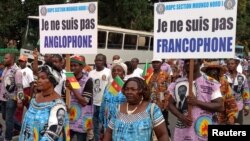 FILE - Demonstrators carry banners as they take part in a march voicing their opposition to independence or more autonomy for the Anglophone regions, in Douala, Cameroon Oct. 1, 2017.