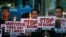 FILE - Protesters hold placards in a candlelit protest against extrajudicial killings in President Rodrigo Duterte's "War on Drugs" campaign in suburban Quezon city, northeast of Manila, Philippines, Oct. 8, 2016. 