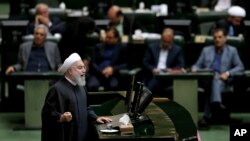 Iranian President Hassan Rouhani speaks during parliament's open session on a confidence vote for four new ministers, in Tehran, Oct. 27, 2018. Rouhani urged parliament to approve four new ministers and help his government "resist" and "fight" the U.S. as it reinstates sanctions against the Islamic Republic.