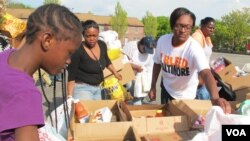 A volunteer in an "I Bleed Baltimore" T-shirt helps pack items at a pop-up food pantry in Baltimore, Maryland, April 30, 2015.