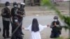 This handout photo by the Myitkyina News Journal shows a nun pleading police not to harm protesters in Myitkyina in Myanmar&#39;s Kachin state, March 8, 2021.