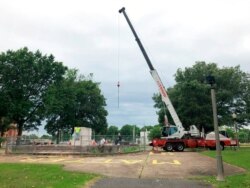 A heavy crane that will be used to help dig up the remains of former Confederate Gen. Nathan Bedford Forrest sits at a park in Memphis, Tenn., June 1, 2021.