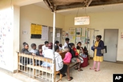 FILE—Barbara Nabulo talks to patients at the children's emergency ward at Mbale Regional Referral Hospital, in Mbale, Uganda Friday, April 26, 2024.