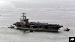 FILE - The nuclear-powered aircraft carrier USS Nimitz is seen in a May 11, 2013, photo. Iran says the vessel approached an offshore oil platform in the Persian Gulf on Friday and a helicopter from the ship buzzed a boat carrying Iranian soldiers.