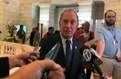 FILE - Former New York City Mayor Michael Bloomberg talks to the media after filing paperwork to appear on the ballot in Arkansas' March 3 presidential primary, in Little Rock, Arkansas, Nov. 12, 2019.