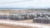 FILE - Tents for detained migrants are seen at the U.S.’s Guantanamo Bay naval station, Cuba, on Feb. 21, 2025. Defense officials told VOA on March 12, 2025, that the last migrants being held there were taken to the mainland to wait for deportation. (U.S. Navy via Reuters)